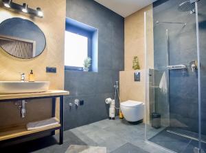 a bathroom with a sink and a shower and a toilet at Rusiński Raj - Domki in Bukowina Tatrzańska +39 photos