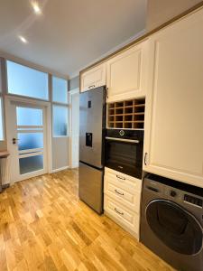 a kitchen with a refrigerator and a dishwasher at !! VIP Apartament Pod BIESZCZADAMI !! in Sanok +7 photos