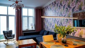 a living room with a blue couch and a table at !! VIP Apartament Pod BIESZCZADAMI !! in Sanok