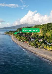 an island with a green sign that reads yoursseek let at Bungalow sur la plage in Le Carbet +2 photos