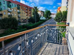 a balcony with a view of a street and buildings at !! VIP Apartament Pod BIESZCZADAMI !! in Sanok
