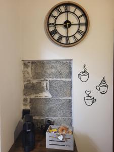 a clock on the wall with cups on it at Casa Mafalda in Campiglia +15 photos