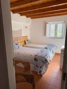 a bedroom with two beds and a window at Vila Brisa do Mar in Comporta +14 photos