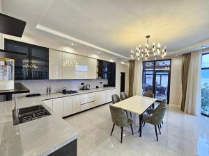 a kitchen and dining room with a table and chairs at Villa Wolverine in Gabala