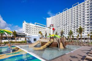 a large hotel with a slide in front of a pool at Riu Ventura - All Inclusive in Cancún