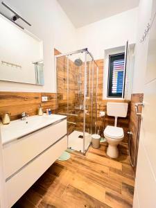 a bathroom with a shower and a toilet and a sink at Le Case di Ciccine' in Bagheria +27 photos