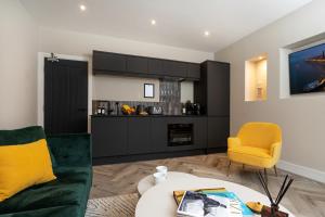 a living room with a couch and a table at Pleasure Beach Apartments by Central Beach Leisure in Blackpool