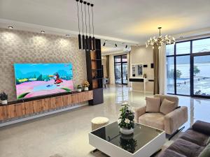 a living room with a tv on a wall at Villa Wolverine in Gabala