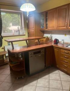 a kitchen with wooden cabinets and a counter top at Second&Home in Przeźmierowo +4 photos