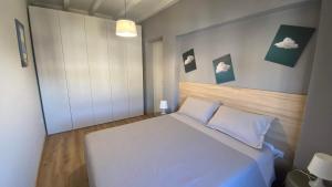 a bedroom with a white bed with two pillows at Appartamento indipendente Apt 3 in Piadena