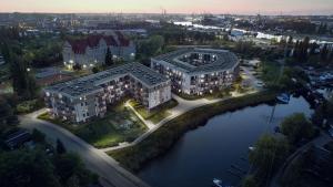 an aerial view of two buildings next to a river at Mostique Spa Apartment with Jacuzzi in Gdańsk
