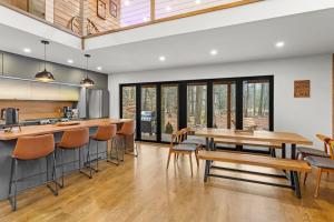 an open kitchen with wooden tables and chairs at Pine Breeze in Pocono Pines