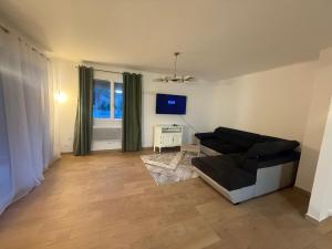 a living room with a couch and a tv at Maison DARDECH in Rochemaure