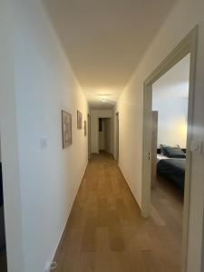 a hallway with a room with a bed and a mirror at Maison DARDECH in Rochemaure