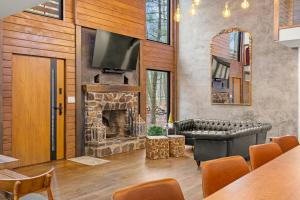 a living room with a couch and a fireplace at Pine Breeze in Pocono Pines