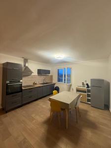 a large kitchen with a table and a tableablish at Maison DARDECH in Rochemaure