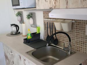 a kitchen sink with a faucet and a counter top at Apartment Melani in Vir +132 photos
