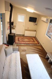 a living room with a couch and a stove at Villa Taraxha in Mitrovica