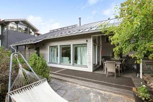 a house with a hammock in front of it at Villa Graniitti in Imatra