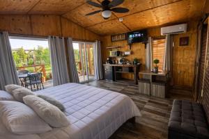 a bedroom with a bed and a ceiling fan at Paraíso del Valle in Ensenada +46 photos