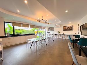a dining room and kitchen with a table and chairs at Stardust Boutique Hotel in Hua Hin