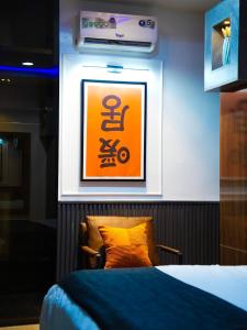 a room with a bed and a picture on the wall at SUITE De PARIS in Abuja
