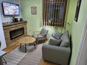 a living room with a couch and a fireplace at APARTMANSKI SMEŠTAJ SOLARIS kod Aqua Parka SUPERIOR & FAMILY Apartments in Soko Banja