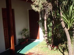 a hallway with trees and plants in a building at Hostal Sur in Villa Gesell