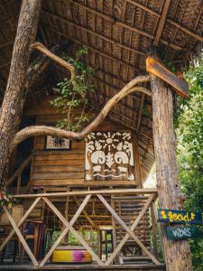 a building with a sign on the side of it at Elephant point tree house in Sigiriya