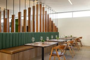 a row of tables and chairs with wine glasses at Courtyard by Marriott Leon at The Poliforum in León