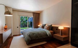 a bedroom with a bed and a large window at Savusavu Sea View in Savusavu