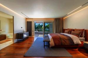 a bedroom with a bed and a flat screen tv at Savusavu Sea View in Savusavu