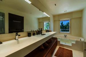 a large bathroom with two sinks and a large mirror at Savusavu Sea View in Savusavu