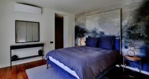 a bedroom with a bed and a painting on the wall at Savusavu Sea View in Savusavu +4 photos