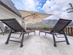 a pair of chairs and an umbrella on a patio at Villa Attilio in Balsorano Vecchio +35 photos