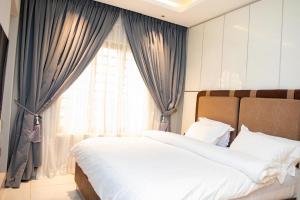 a bedroom with two beds and a window at The Maridoc in Lagos
