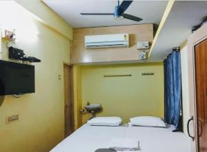 a bedroom with a bed and a air conditioner at JB lodge in Chidambaram