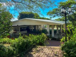 a house with a porch and a street light at Aintree Lodge in Pietermaritzburg