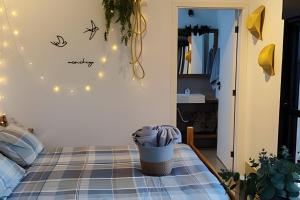 a bedroom with a bed with lights on the wall at Cabana do Café - Olivais Santa Clara in Cambuí +74 photos
