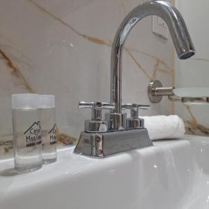 a sink with a glass of water next to it at Depas Ocampo in Morelia