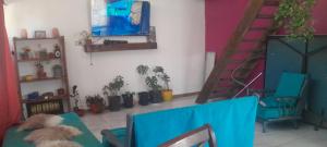 a living room with two chairs and a blue couch at casita de campo in Chillán