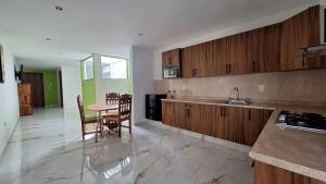 a kitchen with a table and chairs and a dining room at Depas Ocampo in Morelia