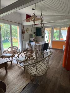 a dining room with a table and chairs at chalet atypique, Ile chambod in Echallon