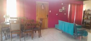 a dining room with a table and chairs at casita de campo in Chillán +1 photo