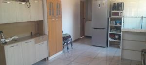 a kitchen with a sink and a refrigerator at casita de campo in Chillán