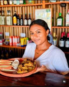 a woman sitting at a table with a plate of food at Entremares in Boca del cielo