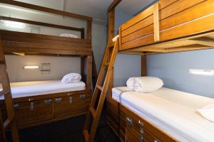 two bunk beds in a small room with at Haka House Queenstown in Queenstown