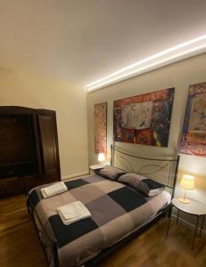 a bedroom with a large bed and a tv at Casa dell'Orso Biella in Biella