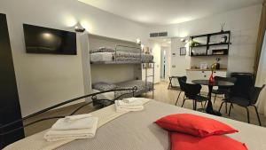 a bedroom with a bed and a living room with a table at Talenti Suites Rome Casa Vacanze in Rome