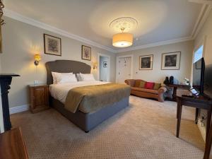 a bedroom with a large bed and a couch at Cashel Regency Townhouse in Cashel